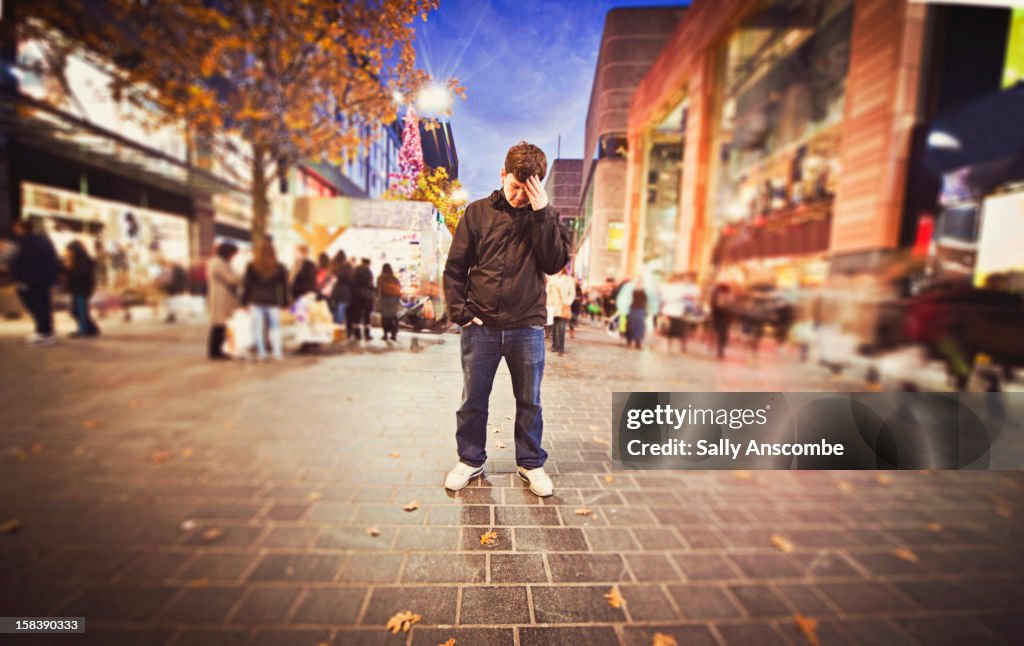 Man stood with his head in his hand