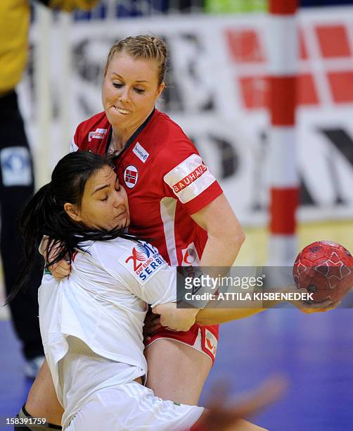 Hungary's Orsolya Verten is fouled by Norway's Karoline Dyhre Breivang during the 2012 EHF European Women's Handball Championship semifinal match...