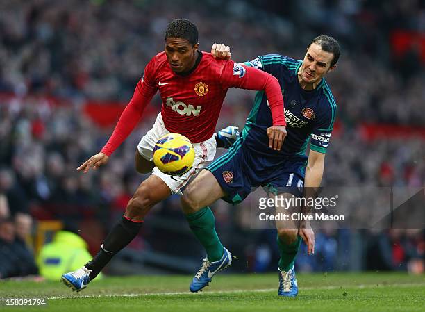 Antonio Valencia of Manchester United is challenged by John O'Shea of Sunderland during the Barclays Premier League match between Manchester United...