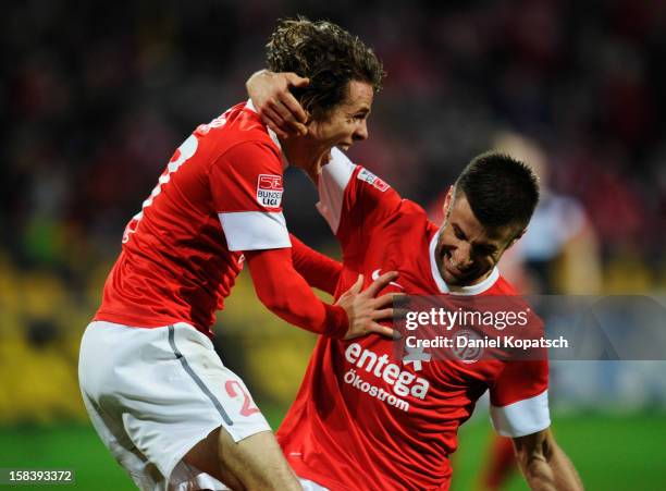 Nicolai Mueller of Mainz celebrates his team's second goal with team mate Marco Caligiuri during the Bundesliga match between 1. FSV Mainz 05 and VfB...