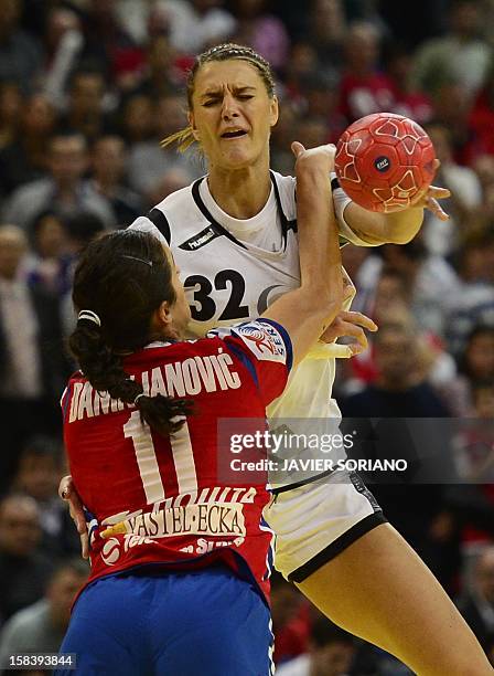 Montenegro's Katarina Bulatovic vies with Serbia's Sanja Damnjanovic during the Women's EHF Euro 2012 Handball Championship semi-final match Serbia...