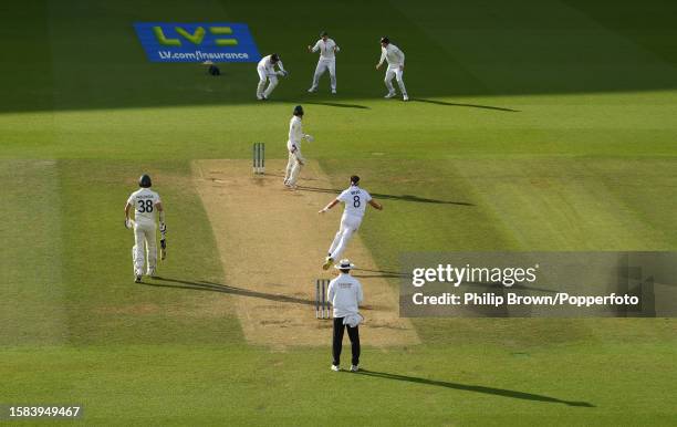 Stuart Broad of England celebrates with Jonny Bairstow, Joe Root and Zak Crawley after the dismissal of Alex Carey of Australia as England won the...