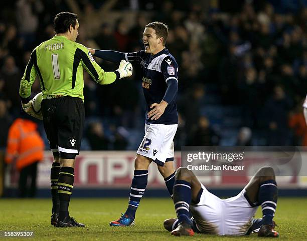 David Forde, Goalkeeper of Millwall celebrates the win with Shane Lowry as team mate Danny Shittu collapses from exhaustion at the final whistle...