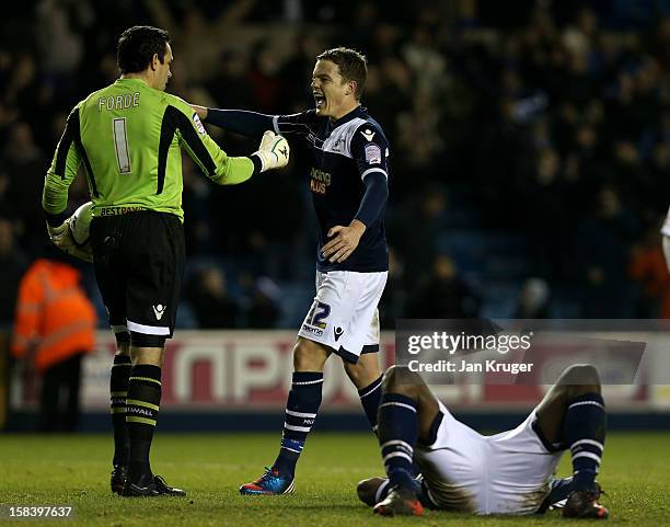 David Forde, Goalkeeper of Millwall celebrates the win with Shane Lowry as tam mate Danny Shittu collapses from exhaustion at the final whistle...