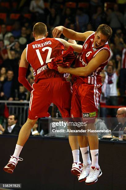 Robin Benzing of Muenchen celebrates victory with his team mate Steffen Hamann after winning the Beko Basketball match between FC Bayern Muenchen and...