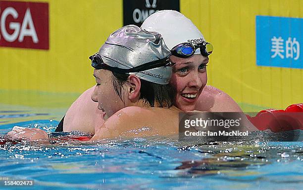 Hannah Miley of Great Britain reacts with Ye Shiwen of China after her third place in the women's 200n IM Final final during day four of the 11th...