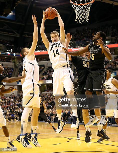 Scott Martin of the Notre Dame Fighting Irish grabs a rebound during the game against the Purdue Boilermakers during Boston Scientific Close The Gap...