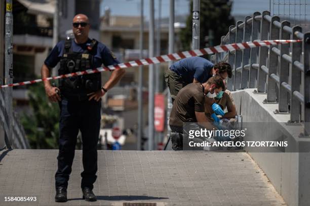 Greek police experts search for evidence outside AEK Athens' OPAP Arena on August 8, 2023 after a Greek football fan was stabbed to death on the...
