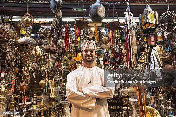 merchant in his shop in the souk of muscat. - oman stockfoto's en -beelden