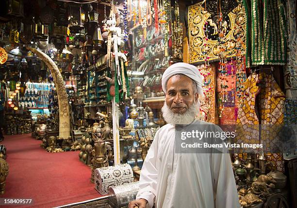 merchant in his shop in the souk of muscat. - zoco fotografías e imágenes de stock