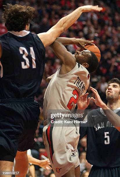 Xavier Thames of the San Diego State Aztecs shoots the ball in the first half of the game against John Sinis of the University of San Diego Tereros...