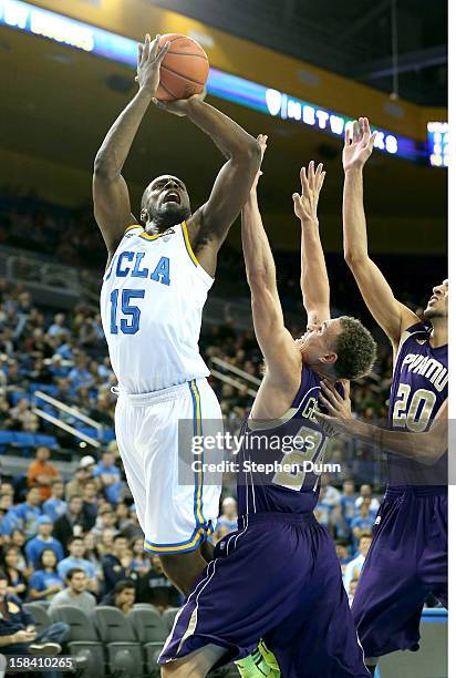 Shabazz Muhammad of the UCLA Bruins shoots over Ryan Gesiakowski and Jules Montgomery of the Prairie View A&M Panthersat Pauley Pavilion on December...