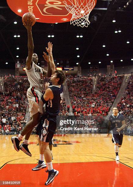 Dwayne Polee of the San Diego State Aztecs shoots the ball in the second half of the game over John Sinis of the University of San Diego Toreros at...