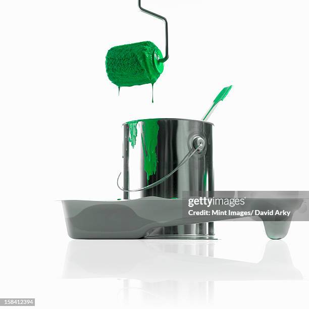 ilustraciones, imágenes clip art, dibujos animados e iconos de stock de a paint roller loaded with green paint dripping on to the metal paintcan and paint tray. - paint tray