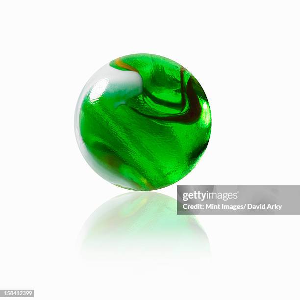 stockillustraties, clipart, cartoons en iconen met a green glass marble with an interior pattern. - glass marble