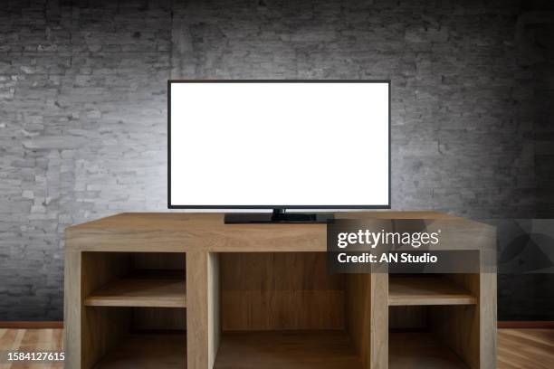 smart tv on the cabinet in modern living room on white wall background. modern white shelf with flat tv at home - smart tv stock-fotos und bilder