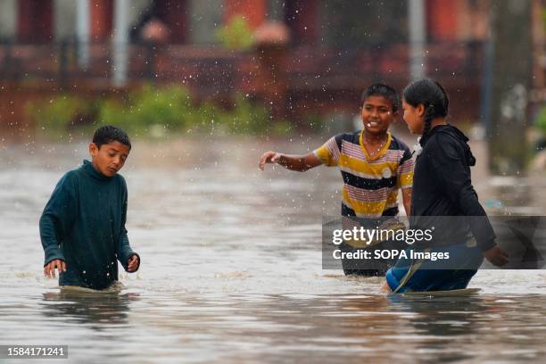 Children play on a flooded area outside their homes after heavy rainfall in Kathmandu. Kathmandu, Nepal experienced severe flooding, resulting in...