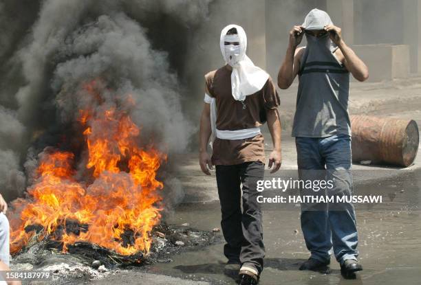 Lebanese Shiite youths burn tires 28 May 2004 during the funeral of Ali Kharfan who was shot dead a day earlier by the Lebanese army during clashes...