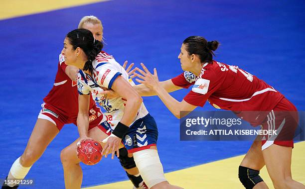 Serbia's Sanja Damnjanovic vies for the ball with Hungary's Kinga Klivinyi and Klara Szekeres during the 2012 EHF European women's Handball...