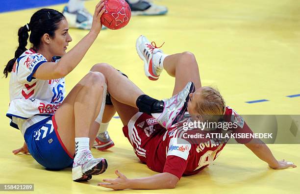 Hungary's Monika Kovacsicz is fouled by Serbia's Sanja Damnjanovic during the 2012 EHF European women's Handball Championship small final match...