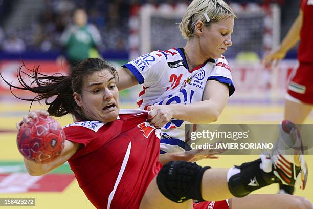 Hungary's Orsolya Verten vies for the ball with Serbia's Ivana Milosevic during the women's EHF Euro 2012 Handball Championship small final match...