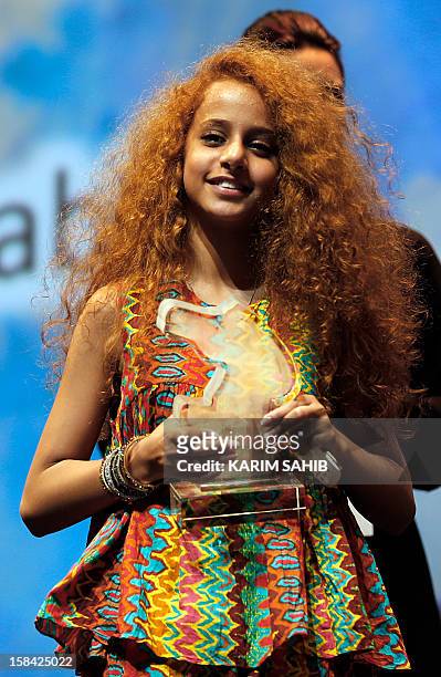 Saudi Actress Waad Mohammed accepts the Muhr Arab Feature award for her film "Wadjda" during the at the Dubai International Film Festival in the Gulf...