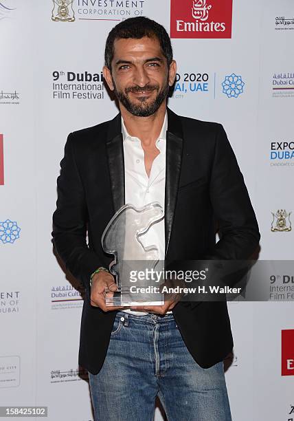 Actor Amr Waked with the Muhr Arab Feature Best Actor award during the Closing Ceremony on day eight of the 9th Annual Dubai International Film...