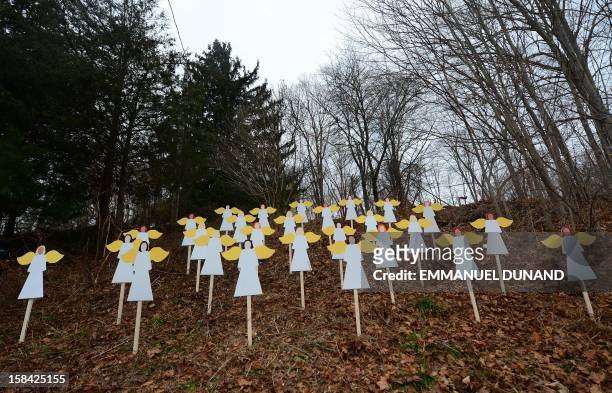 Twenty seven angel wood cut-outs are set up on hillside in memory to the victims of an elementary school shooting in Newtown, Connecticut, December...
