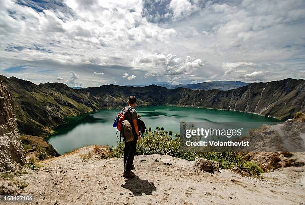young backpacker looking to the stunning quilotoa - ecuador cotopaxi stock pictures, royalty-free photos & images