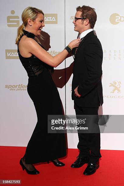 Girl friend Caroline adjusts the tie of Fabian Hambuechen after their arrival at the 'Athlete of the Year 2012' gala at the Kurhaus Baden-Baden on...