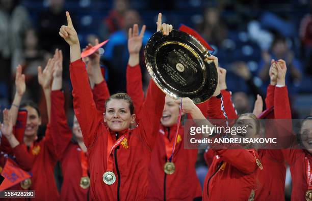 Montenegro's players hold their trophy as they celebrate their team victory after the Women's EHF Euro 2012 Handball Championship final match Norway...