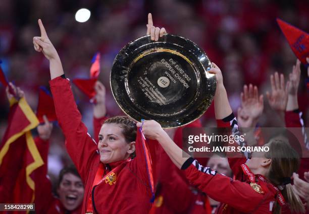 Montenegro's players hold their trophy as they celebrate their team victory after the Women's EHF Euro 2012 Handball Championship final match Norway...