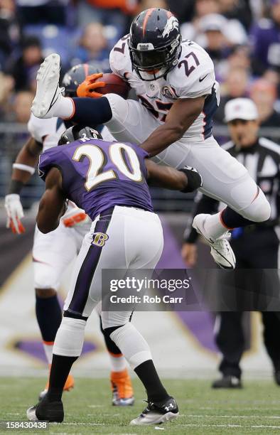 Running back Knowshon Moreno of the Denver Broncos jumps over free safety Ed Reed of the Baltimore Ravens while rushing the ball during the first...