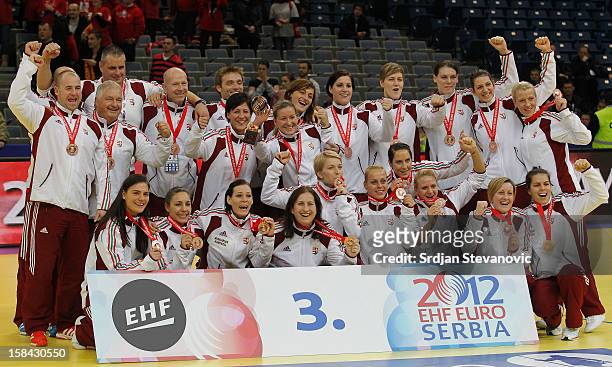 Hungary's players pose on podium after taking the third place during the Women's European Handball Championship 2012 medal ceremony at Arena Hall on...