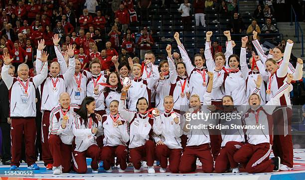 Hungary's players pose on podium after taking the third place during the Women's European Handball Championship 2012 medal ceremony at Arena Hall on...