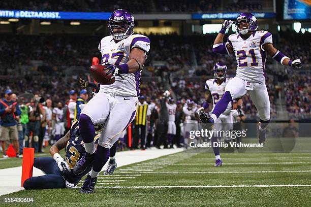 Everson Griffen of the Minnesota Vikings scores a touchdown after incepting a pass against the St. Louis Rams at the Edward Jones Dome on December...