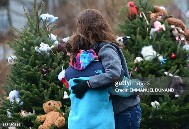 People grieve at a makeshift shrine to the victims of a elementary school shooting in Newtown, Connecticut, December 16, 2012. A young gunman...