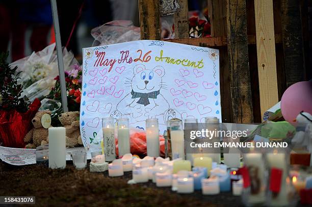 Sign at a makeshift shrine to the victims of a elementary school shooting in Newtown, Connecticut, December 16, 2012. A young gunman slaughtered 20...