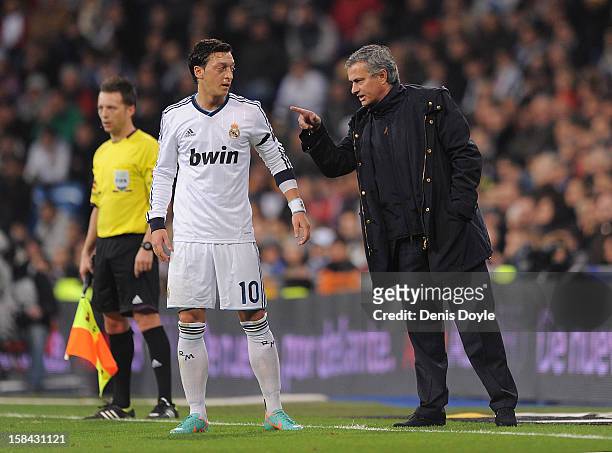 Real Madrid CF head coach Jose Mourinho talks with Mesut Ozil of Real Madrid during the La Liga match between Real Madrid CF and RCD Espanyol at...