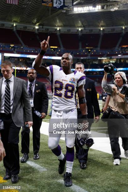 Adrian Peterson of the Minnesota Vikings gestures toward fans after the game against the St. Louis Rams at Edward Jones Dome on December 16, 2012 in...