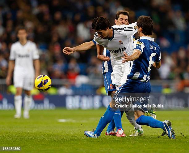 Sami Khedira of Real Madrid and Juan Forlin competes for the ball during the La Liga match between Real Madrid and RCD Espanyol at Santiago Bernabeu...