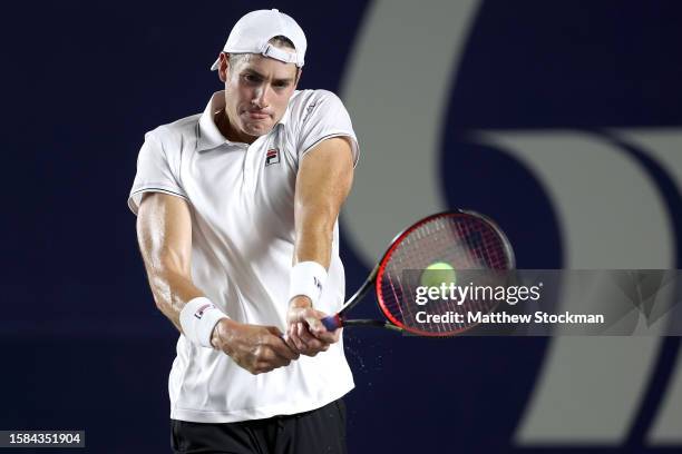 John Isner of the United States returns a shot to Rinky Hijikata of Australia during the Mifel Tennis Open by Telcel Oppo at Cabo Sports Complex on...