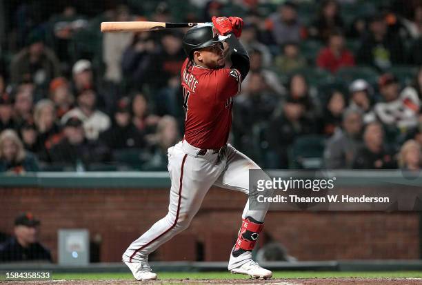 Ketel Marte of the Arizona Diamondbacks hits an RBI double to score Geraldo Perdomo against the San Francisco Giants in the top of the 11th inning at...