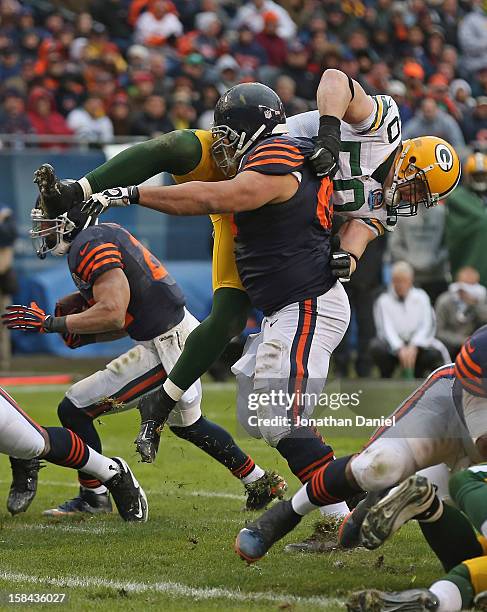 Roberto Garza of the Chicago Bears flips A.J. Hawk of the Green Bay Packers at Soldier Field on December 16, 2012 in Chicago, Illinois. The Packers...