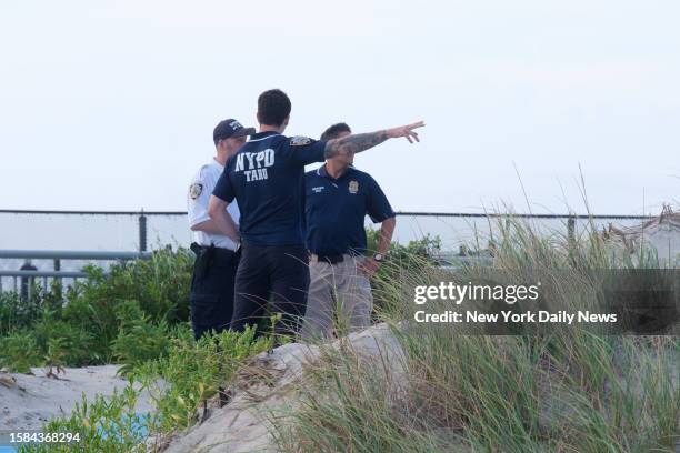 August 7: Police respond to Rockaway Beach at Beach 59th Street in Queens, New York City after a swimmer was attacked by a shark on Monday, August 7,...