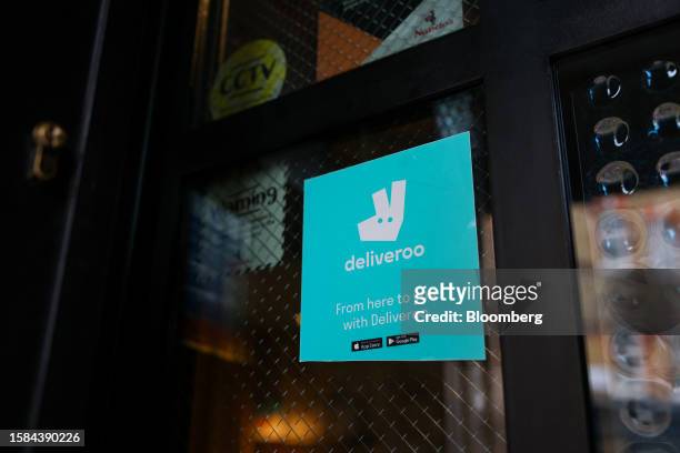 Sticker for Deliveroo Plc on a restaurant window in London, UK, on Tuesday, Aug. 8, 2023. Deliveroo will release their first-half earnings on...