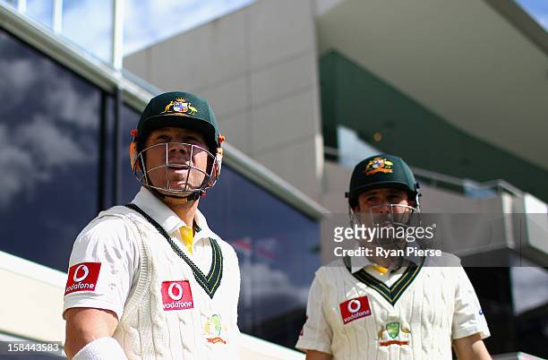 David Warner and Ed Cowan of Australia walk out to bat during day four of the First Test match between Australia and Sri Lanka at Blundstone Arena on...