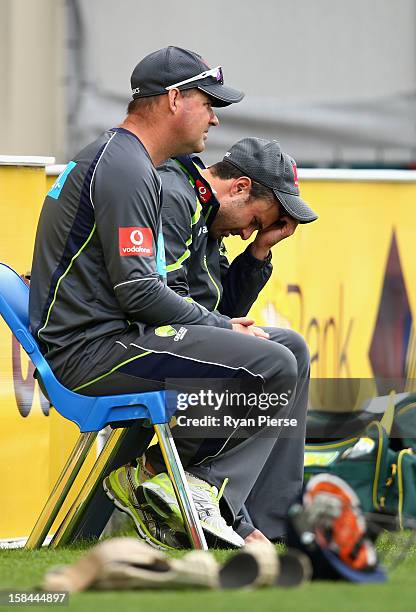 Ed Cowan of Australia speaks with Mickey Arthur, coach of Australia during day four of the First Test match between Australia and Sri Lanka at...