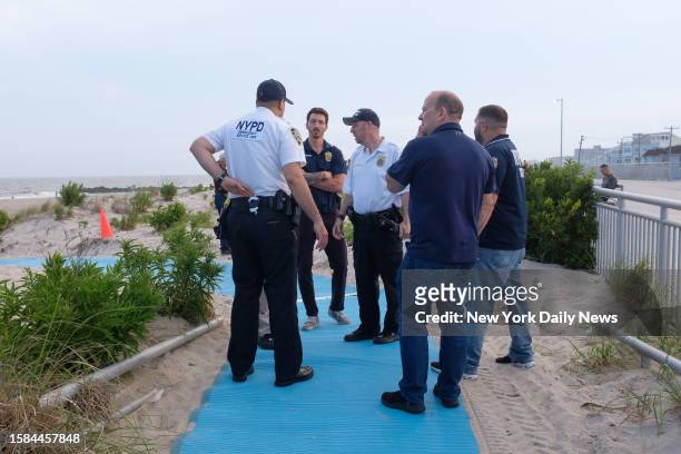Police respond to Rockaway Beach at Beach 59th Street in Queens, New York City after a swimmer was attacked by a shark on Monday, Aug. 7, 2023.