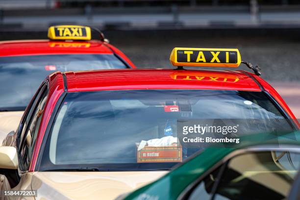 Dubai Roads and Transport Authority taxis wait for passengers outside a metro station in the downtown district of Dubai, United Arab Emirates, on...